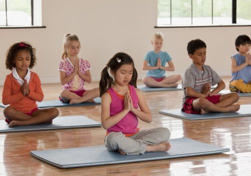 Children exercising in yoga class
